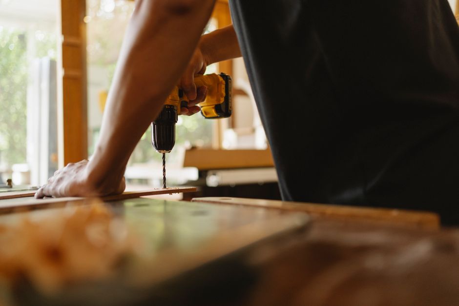 Carpenter carefully installing a wooden door